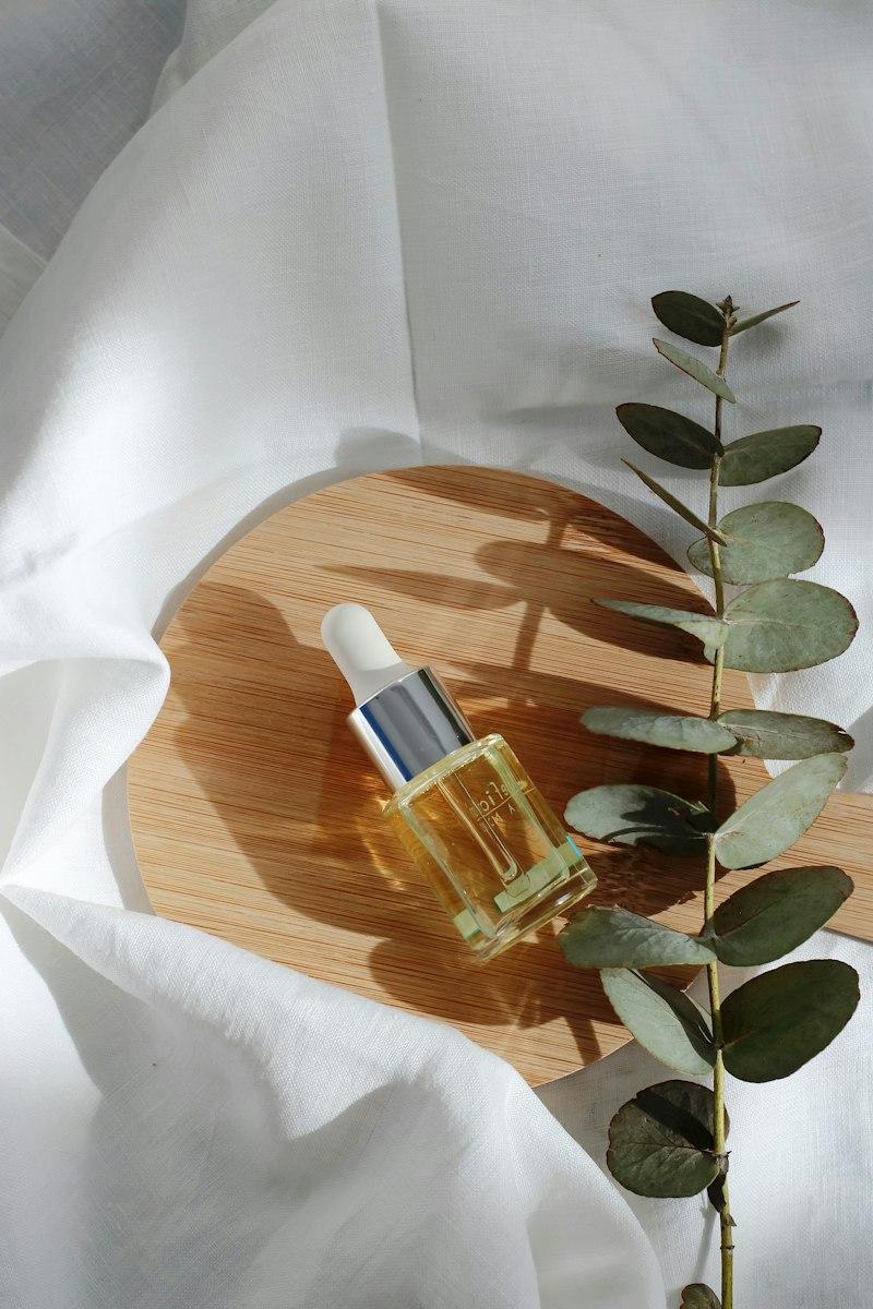 Dropper bottle of botanical hair oil with rosemary sprigs