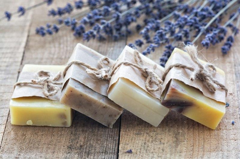 Stack of handmade cold-process soap bars with botanical swirls